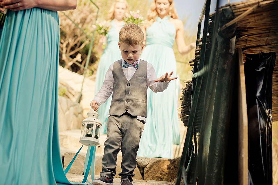 A destinatoin wedding in Zakynthos, Greece. The bride wears Ronald Joyce and her maids wear twobirds Bridesmaid.  Photography by Nick Kontostavlakis.