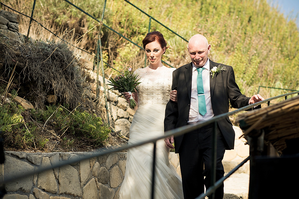 A destinatoin wedding in Zakynthos, Greece. The bride wears Ronald Joyce and her maids wear twobirds Bridesmaid.  Photography by Nick Kontostavlakis.