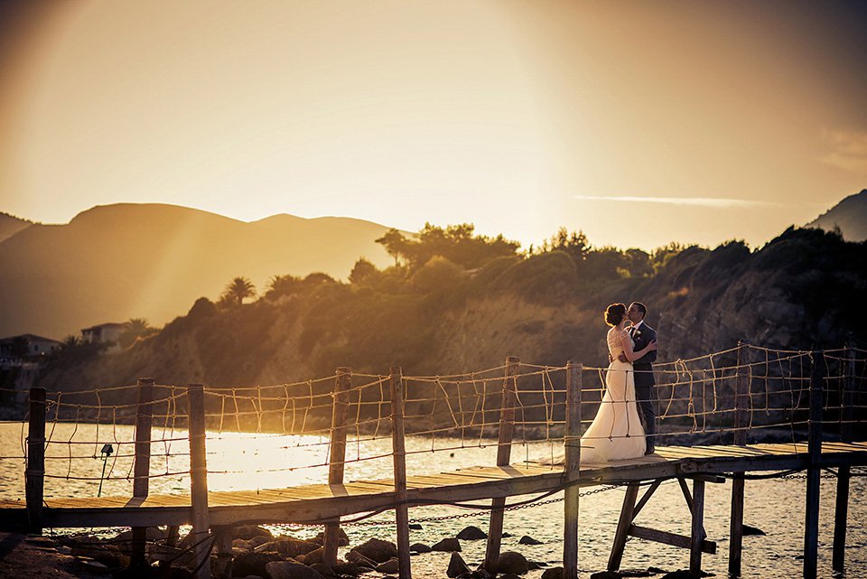 A destinatoin wedding in Zakynthos, Greece. The bride wears Ronald Joyce and her maids wear twobirds Bridesmaid.  Photography by Nick Kontostavlakis.