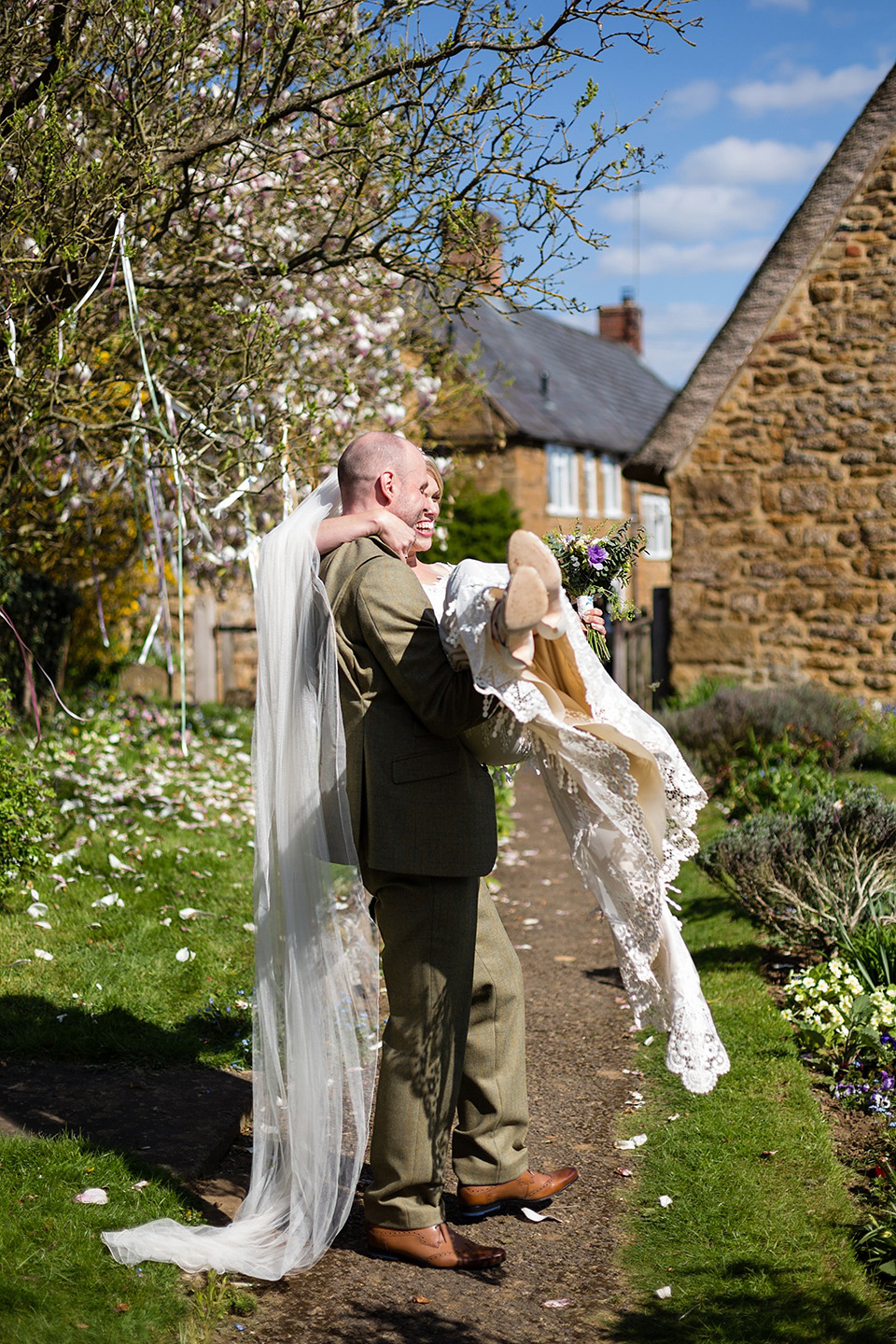 An elegant English wedding in the Spring. The bride wears Kristene by Claire Pettibone. Photography by Jo Hastings.