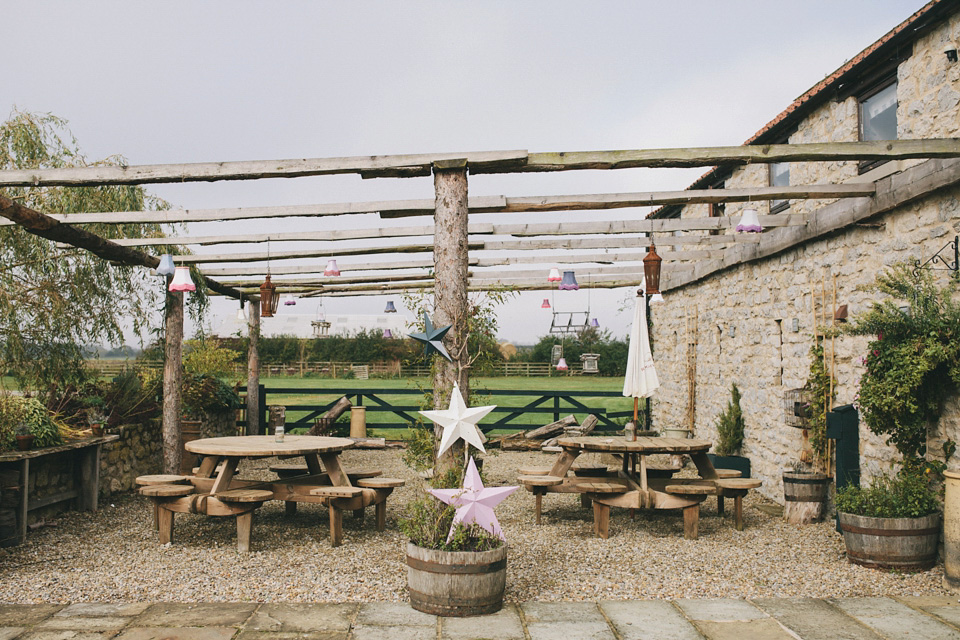 An elegant rustic Autumn wedding with a bride wearing flowers in her hair. Photography by Sally T.