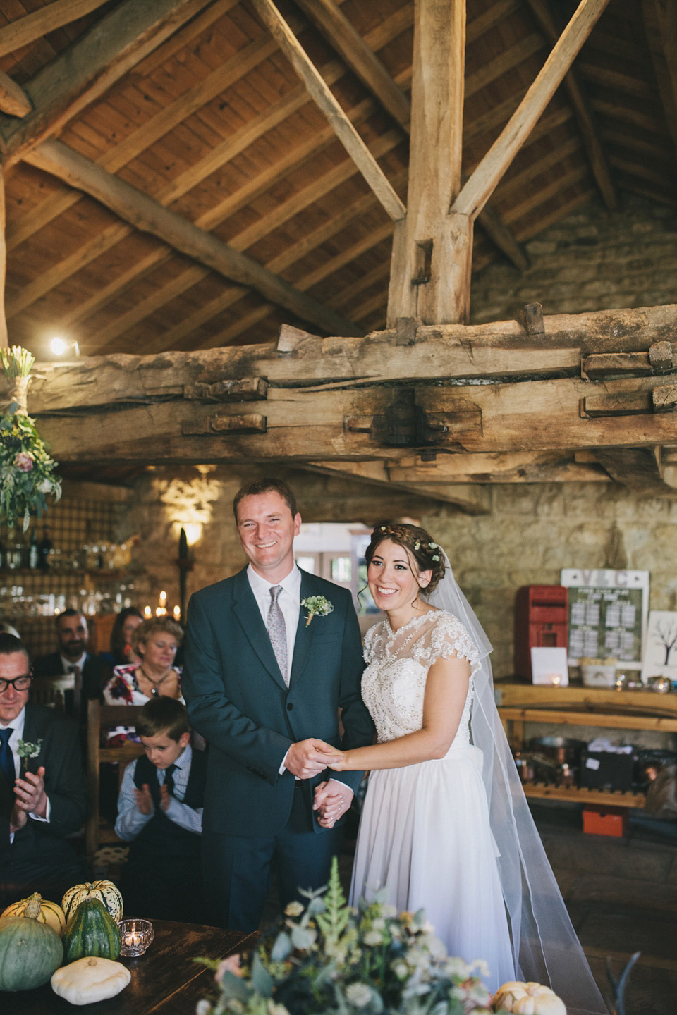 An elegant rustic Autumn wedding with a bride wearing flowers in her hair. Photography by Sally T.