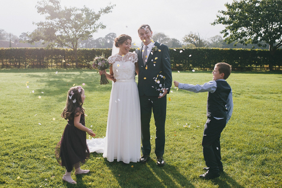 An elegant rustic Autumn wedding with a bride wearing flowers in her hair. Photography by Sally T.