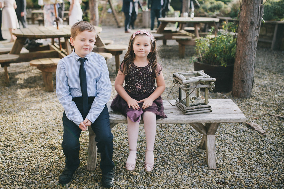 An elegant rustic Autumn wedding with a bride wearing flowers in her hair. Photography by Sally T.