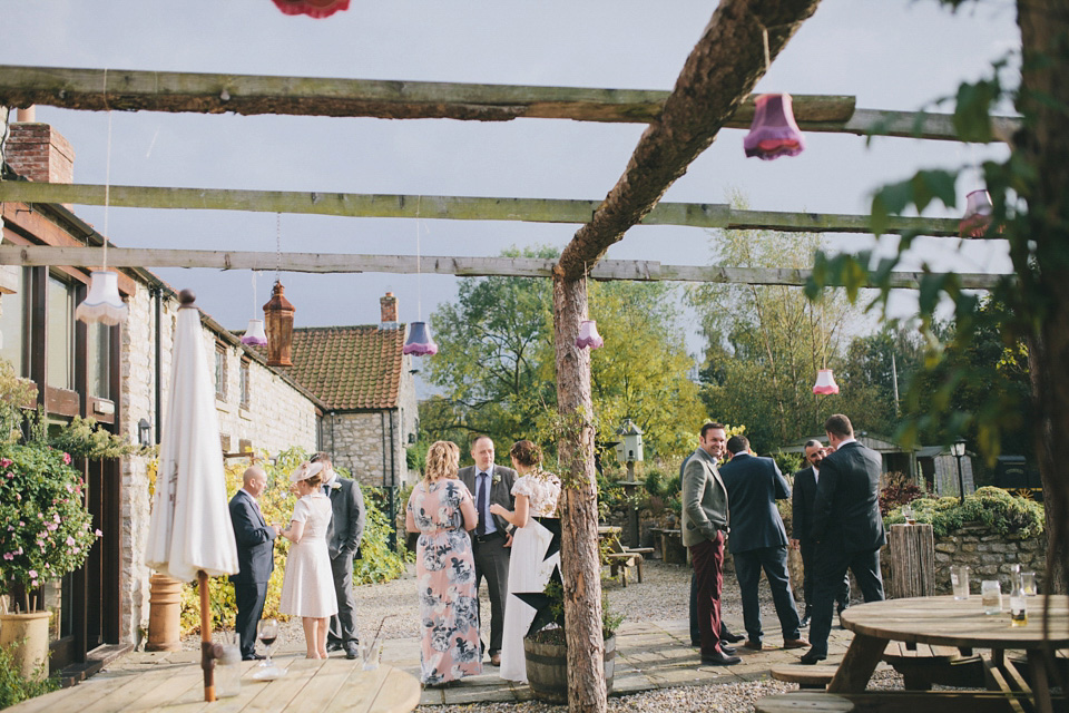 An elegant rustic Autumn wedding with a bride wearing flowers in her hair. Photography by Sally T.