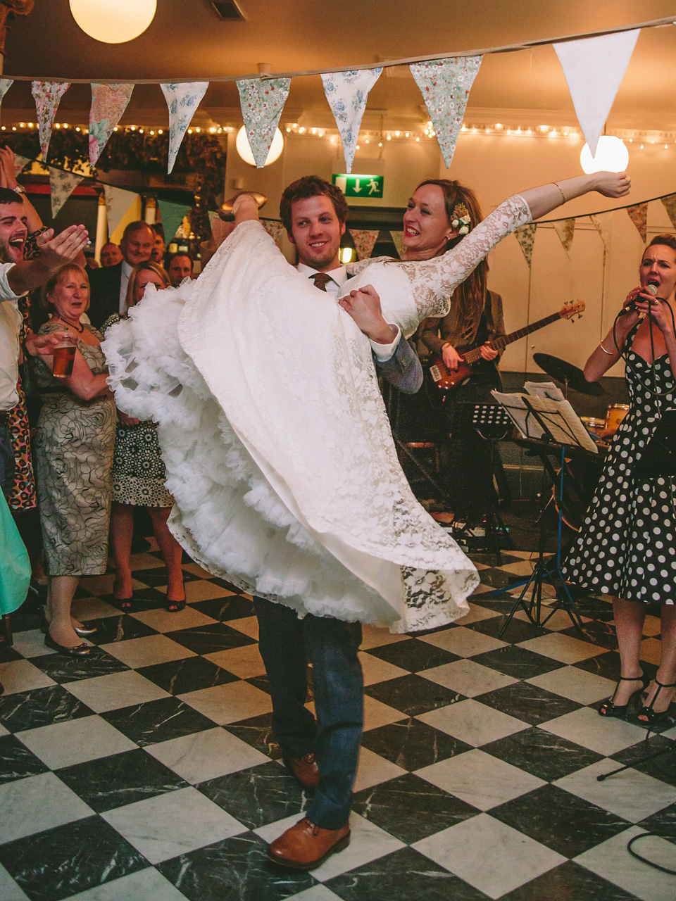 The bride wears a 1950's vintage inspired wedding dress by Fur Coat No Knickers for their very British London pub wedding. Photography by Marc Hayden.