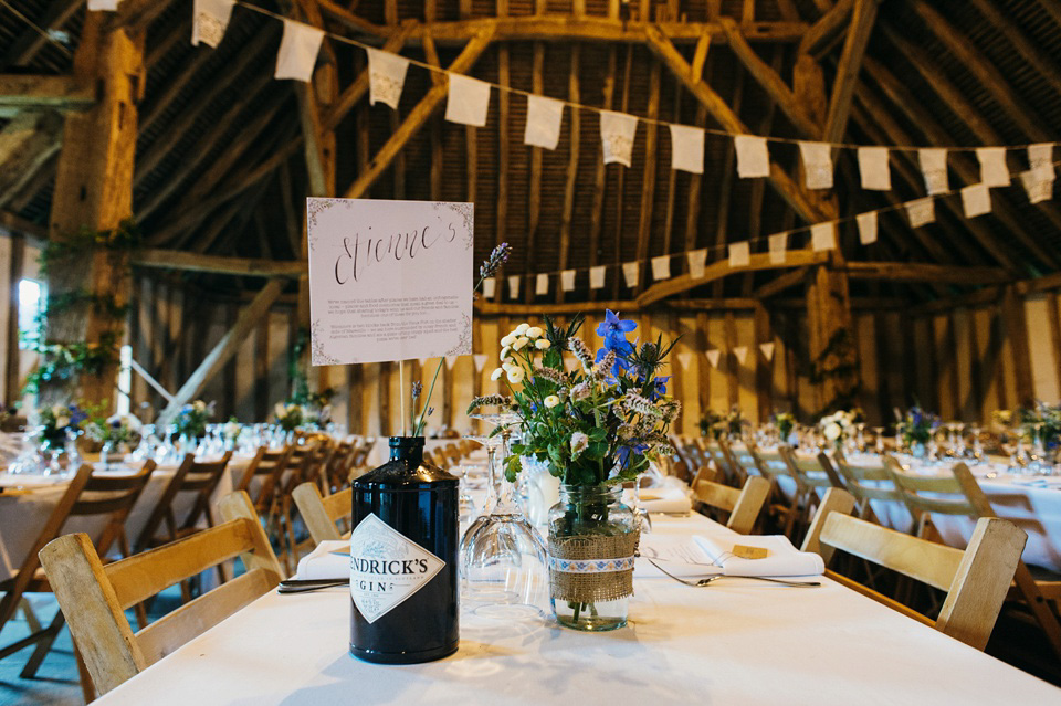 A pretty pale blue summer Barn wedding. The bride wears Jenny Packham and a floral crown. Image by Babb Photography