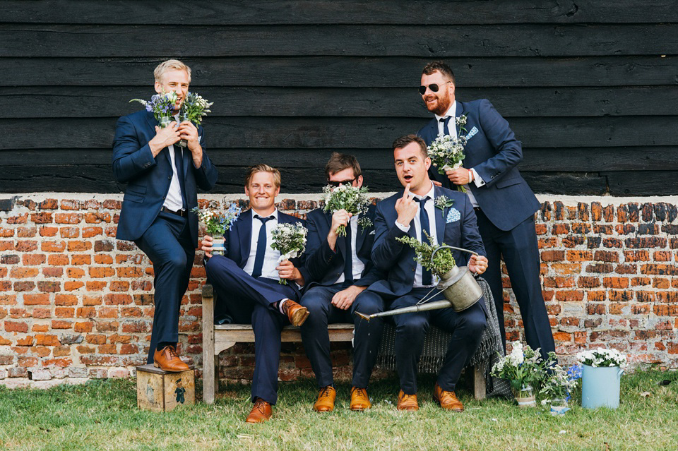 A pretty pale blue summer Barn wedding. The bride wears Jenny Packham and a floral crown. Image by Babb Photography