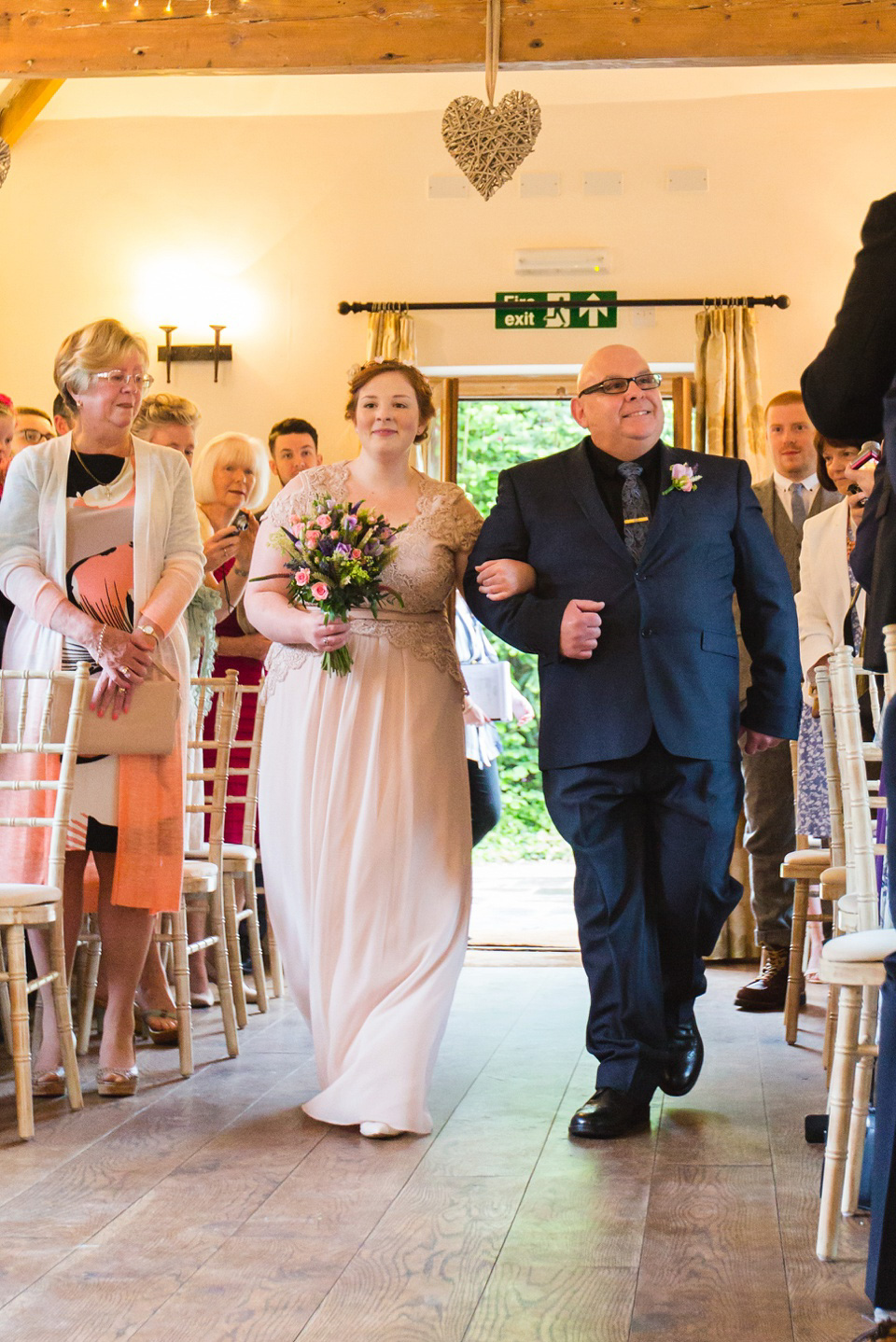 The bride wears a Jacques Vert dress from Debenhams for her Welsh country house wedding.