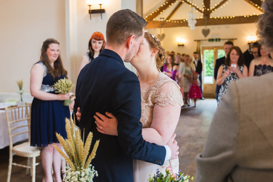 The bride wears a Jacques Vert dress from Debenhams for her Welsh country house wedding.