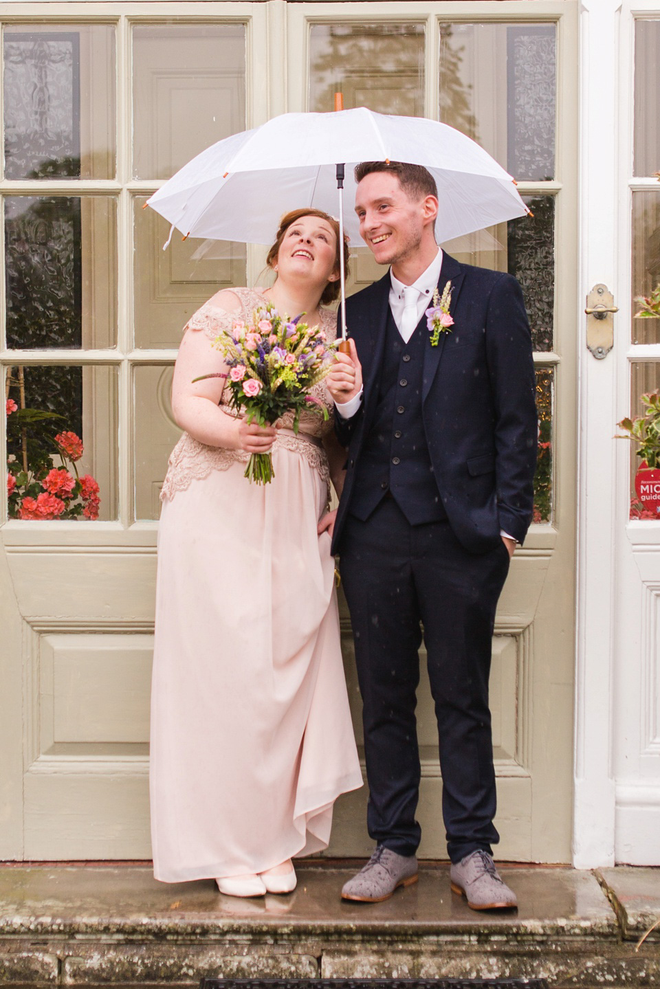 The bride wears a Jacques Vert dress from Debenhams for her Welsh country house wedding.