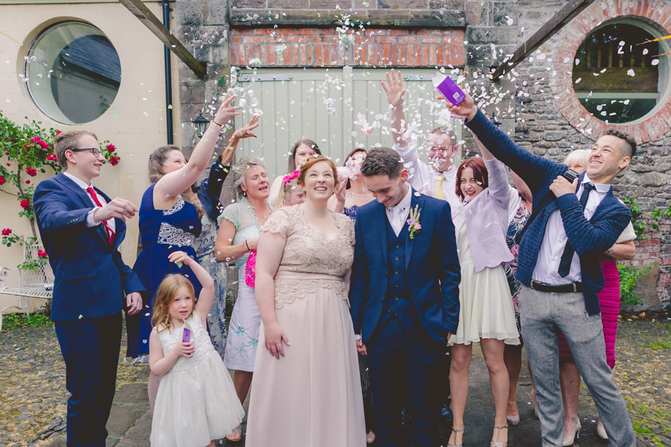 The bride wears a Jacques Vert dress from Debenhams for her Welsh country house wedding.