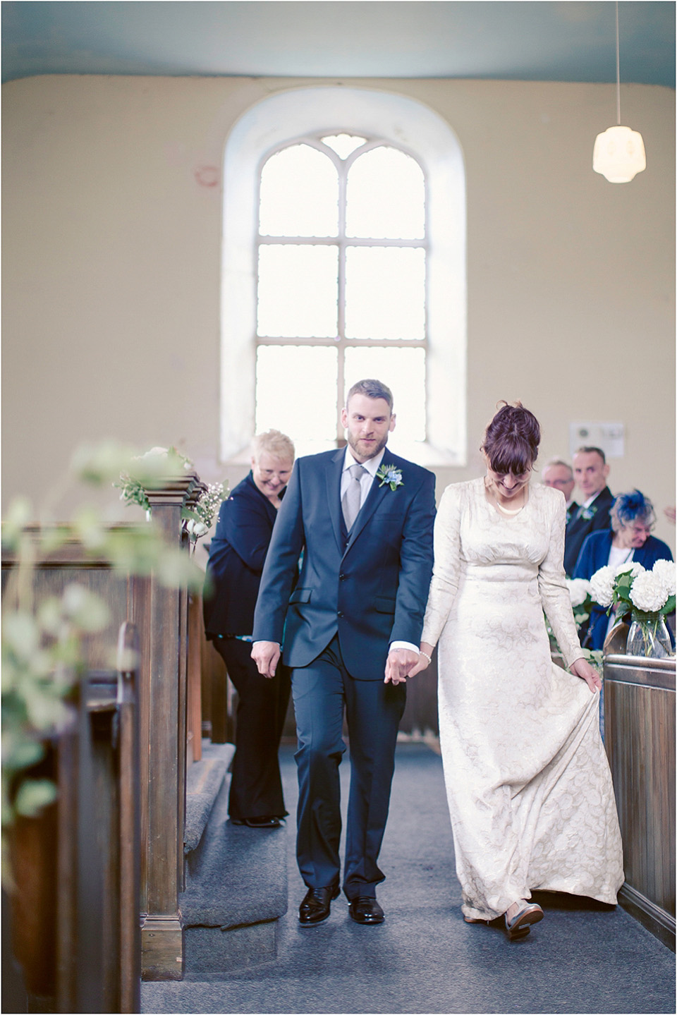 The bride wears a 1930s original vintage wedding gown for her village hall wedding in Scotland. Photography by Michelle Turnbull.