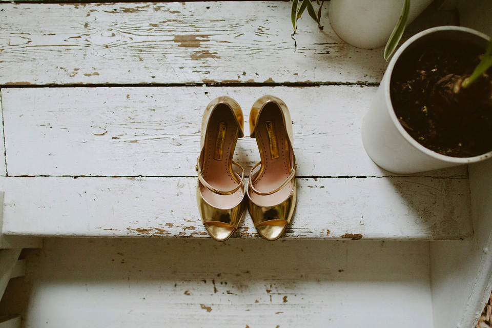 The bride wears Vivienne Westwood and Gold Rupert Sanderson shoes for her wedding at The Asylum in Peckham, London. Photography by David Jenkins.