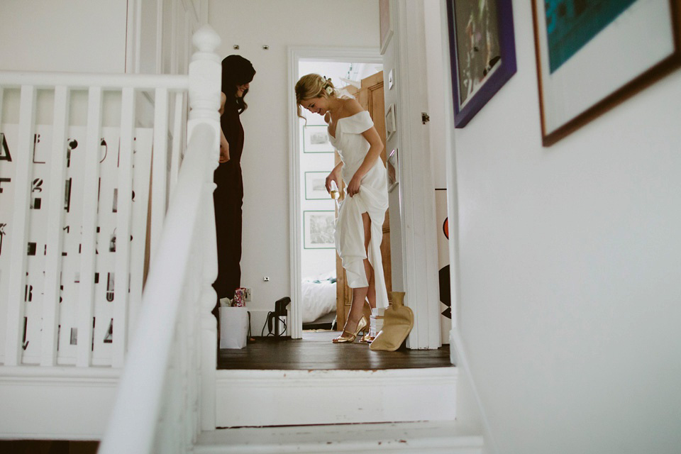 The bride wears Vivienne Westwood and Gold Rupert Sanderson shoes for her wedding at The Asylum in Peckham, London. Photography by David Jenkins.