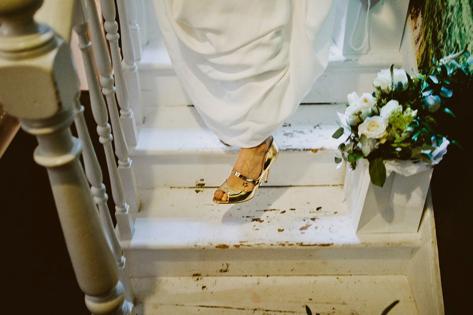 The bride wears Vivienne Westwood and Gold Rupert Sanderson shoes for her wedding at The Asylum in Peckham, London. Photography by David Jenkins.