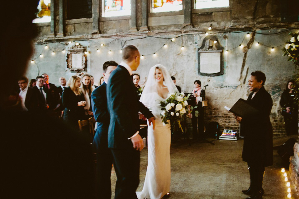 The bride wears Vivienne Westwood and Gold Rupert Sanderson shoes for her wedding at The Asylum in Peckham, London. Photography by David Jenkins.