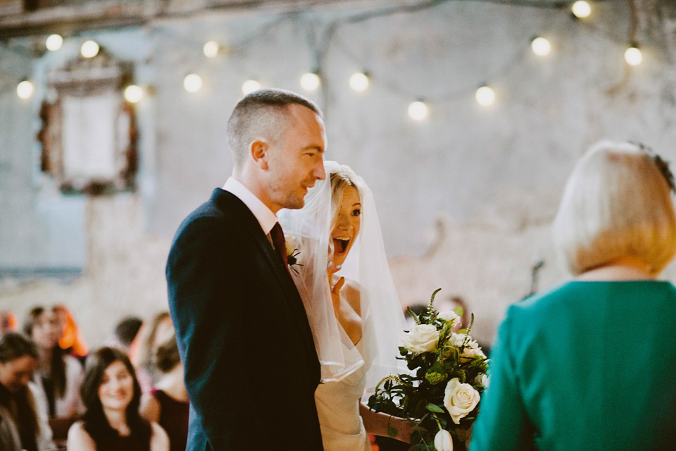 The bride wears Vivienne Westwood and Gold Rupert Sanderson shoes for her wedding at The Asylum in Peckham, London. Photography by David Jenkins.