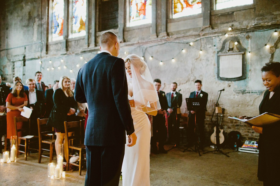 The bride wears Vivienne Westwood and Gold Rupert Sanderson shoes for her wedding at The Asylum in Peckham, London. Photography by David Jenkins.