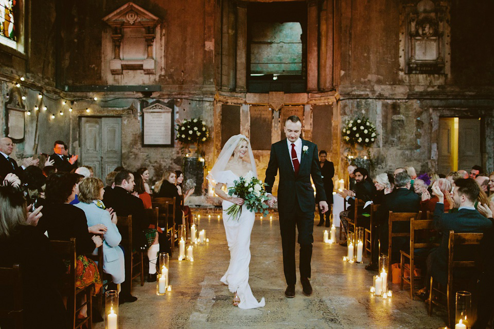 The bride wears Vivienne Westwood and Gold Rupert Sanderson shoes for her wedding at The Asylum in Peckham, London. Photography by David Jenkins.