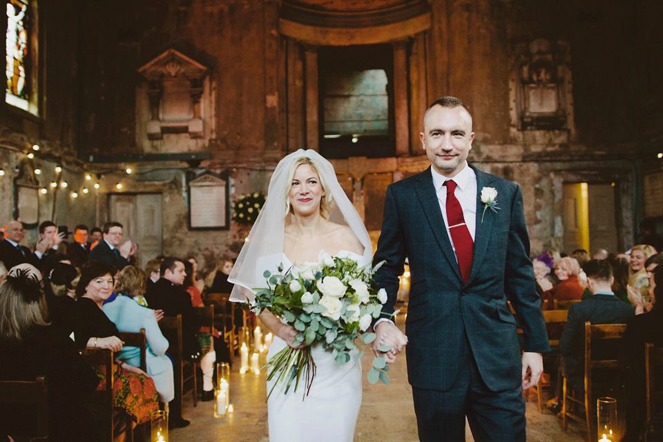 The bride wears Vivienne Westwood and Gold Rupert Sanderson shoes for her wedding at The Asylum in Peckham, London. Photography by David Jenkins.