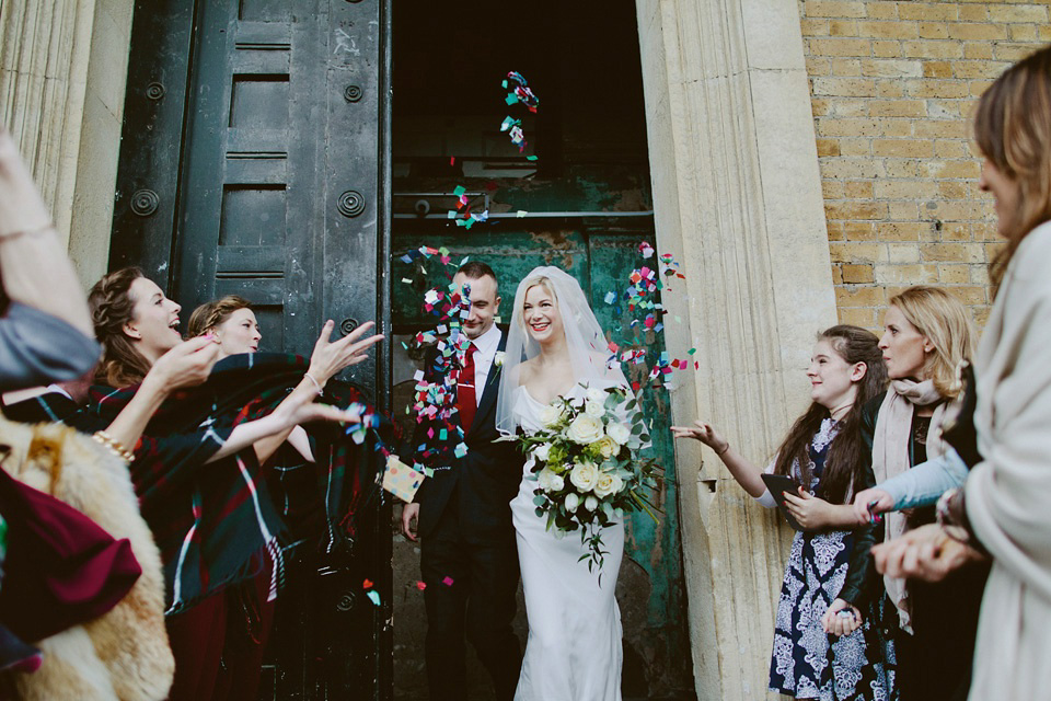 The bride wears Vivienne Westwood and Gold Rupert Sanderson shoes for her wedding at The Asylum in Peckham, London. Photography by David Jenkins.