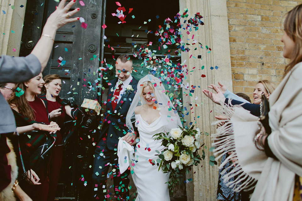 The bride wears Vivienne Westwood and Gold Rupert Sanderson shoes for her wedding at The Asylum in Peckham, London. Photography by David Jenkins.