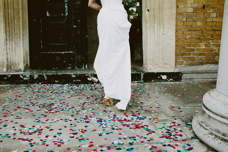 The bride wears Vivienne Westwood and Gold Rupert Sanderson shoes for her wedding at The Asylum in Peckham, London. Photography by David Jenkins.
