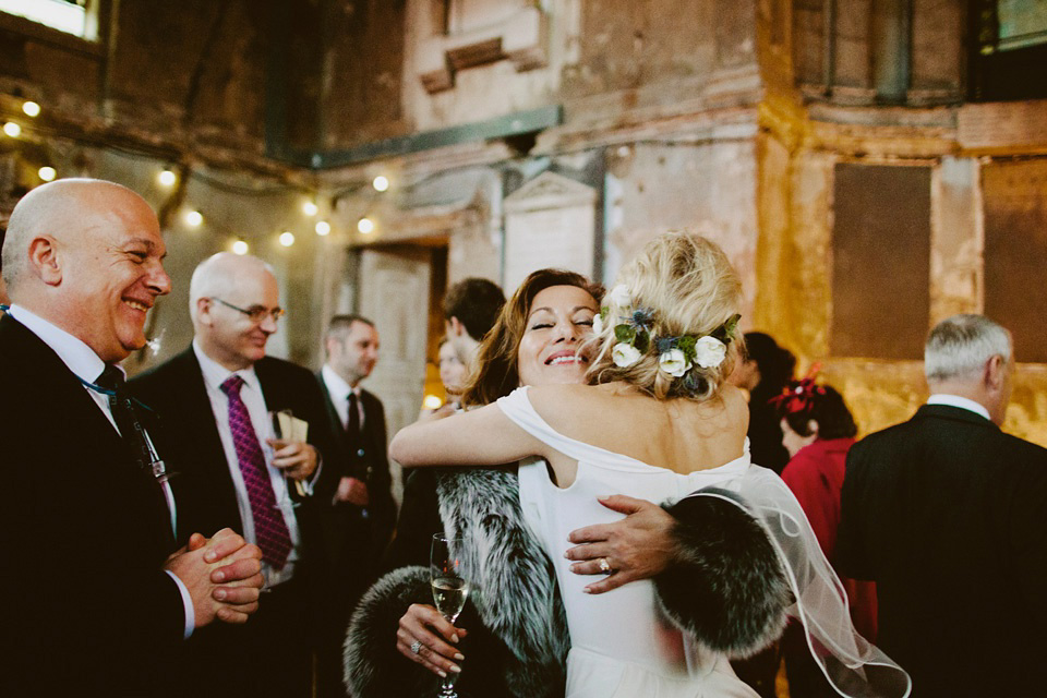 The bride wears Vivienne Westwood and Gold Rupert Sanderson shoes for her wedding at The Asylum in Peckham, London. Photography by David Jenkins.