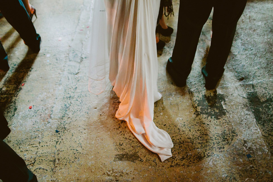 The bride wears Vivienne Westwood and Gold Rupert Sanderson shoes for her wedding at The Asylum in Peckham, London. Photography by David Jenkins.