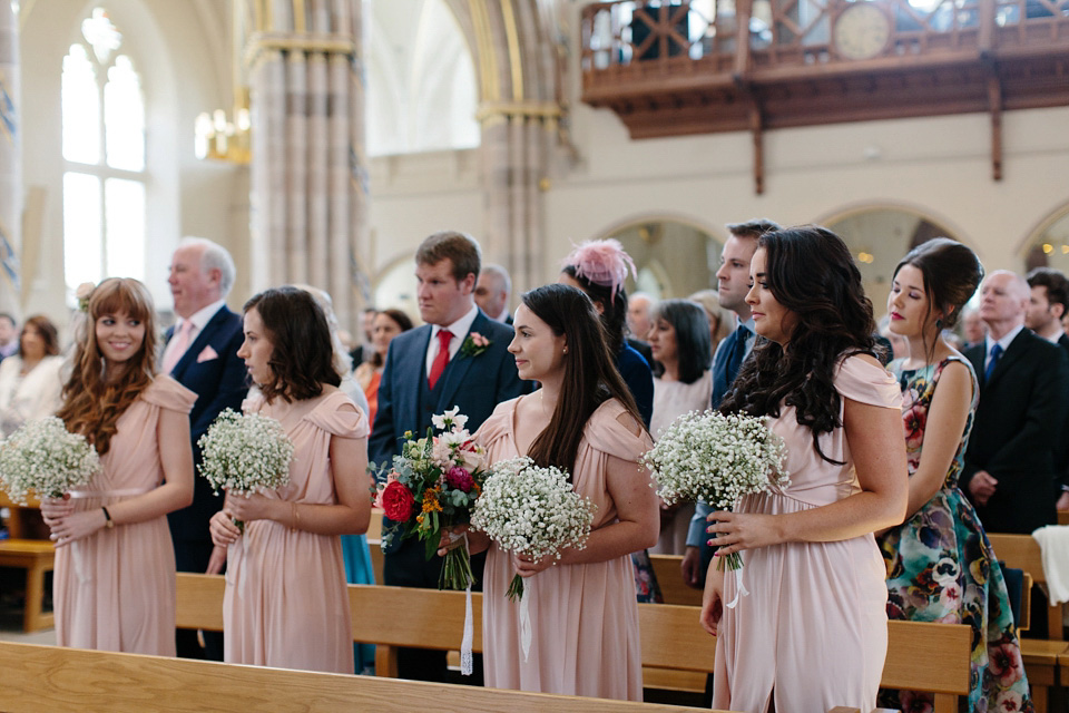 The bride wears a Rowanjoy dress and rose gold Twigs and Honey headpiece for her June wedding in Scotland. Photography by Caro Weiss.