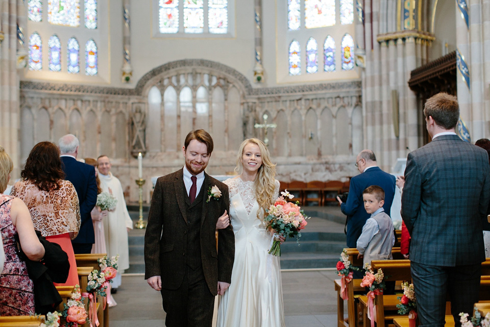 The bride wears a Rowanjoy dress and rose gold Twigs and Honey headpiece for her June wedding in Scotland. Photography by Caro Weiss.