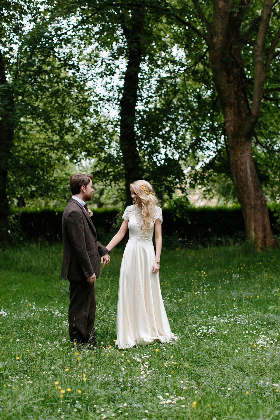 The bride wears a Rowanjoy dress and rose gold Twigs and Honey headpiece for her June wedding in Scotland. Photography by Caro Weiss.