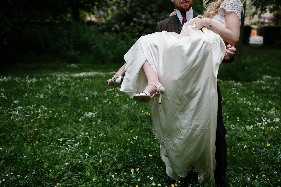 The bride wears a Rowanjoy dress and rose gold Twigs and Honey headpiece for her June wedding in Scotland. Photography by Caro Weiss.