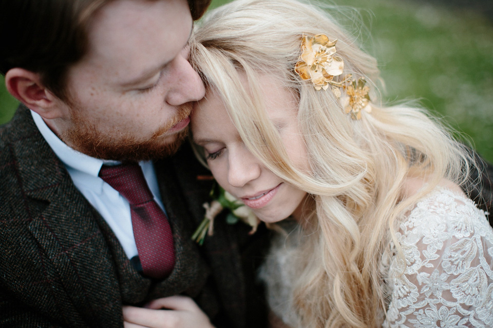 The bride wears a Rowanjoy dress and rose gold Twigs and Honey headpiece for her June wedding in Scotland. Photography by Caro Weiss.