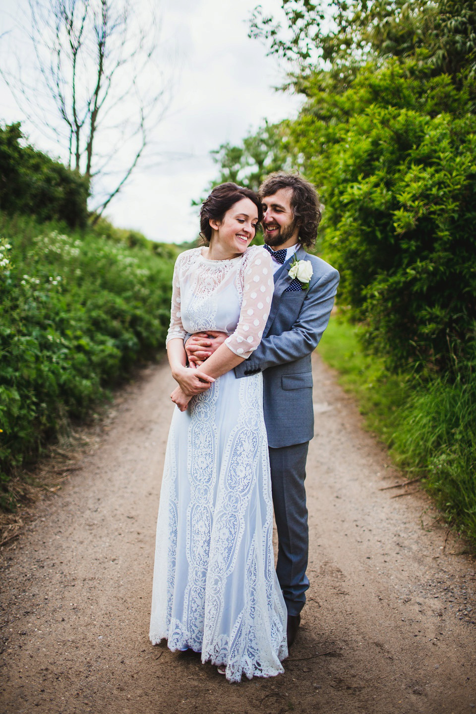 The bride wears a pale blue dress by Katya Katya Shehurina for her Spring, rural style wedding at Great Street Barn. Photography by Amy B.