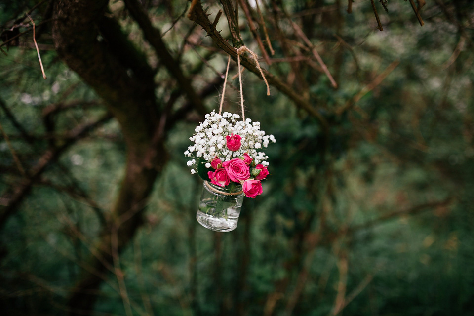 The bride wears a Sabina Motasem gown for her rustic, festival style wedding with glamping near the forrest. Photography by Joanna Nicole.