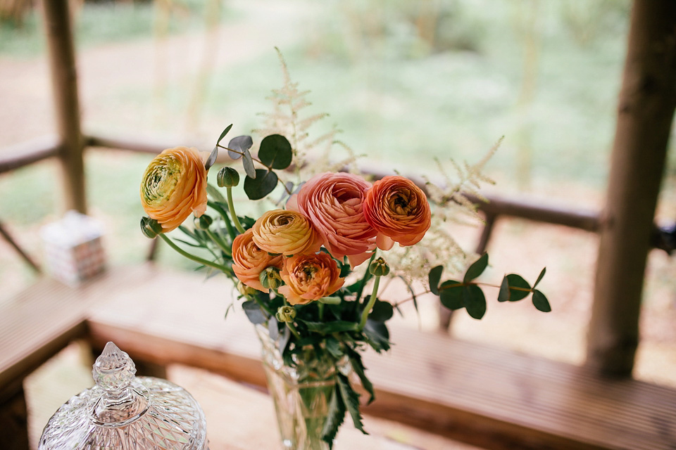 The bride wears a Sabina Motasem gown for her rustic, festival style wedding with glamping near the forrest. Photography by Joanna Nicole.