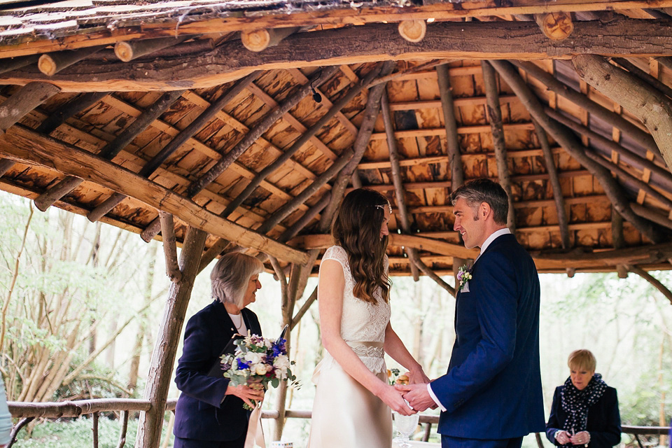 The bride wears a Sabina Motasem gown for her rustic, festival style wedding with glamping near the forrest. Photography by Joanna Nicole.