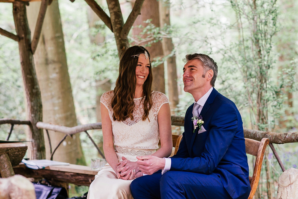 The bride wears a Sabina Motasem gown for her rustic, festival style wedding with glamping near the forrest. Photography by Joanna Nicole.