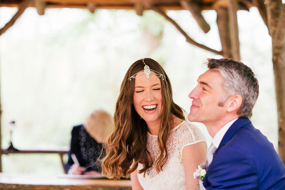 The bride wears a Sabina Motasem gown for her rustic, festival style wedding with glamping near the forrest. Photography by Joanna Nicole.