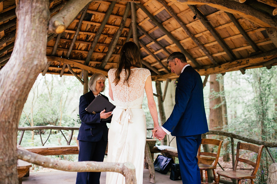 The bride wears a Sabina Motasem gown for her rustic, festival style wedding with glamping near the forrest. Photography by Joanna Nicole.