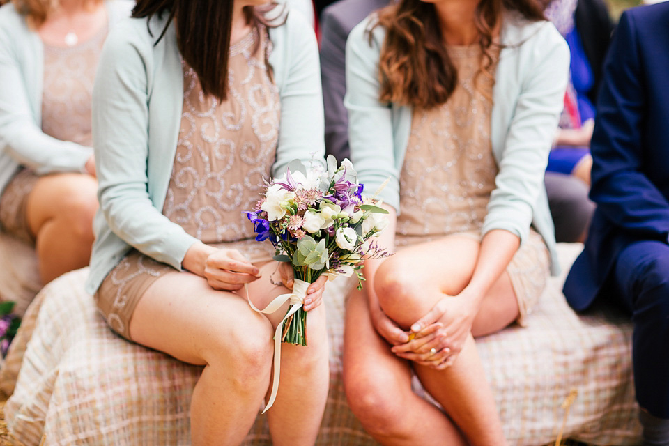 The bride wears a Sabina Motasem gown for her rustic, festival style wedding with glamping near the forrest. Photography by Joanna Nicole.