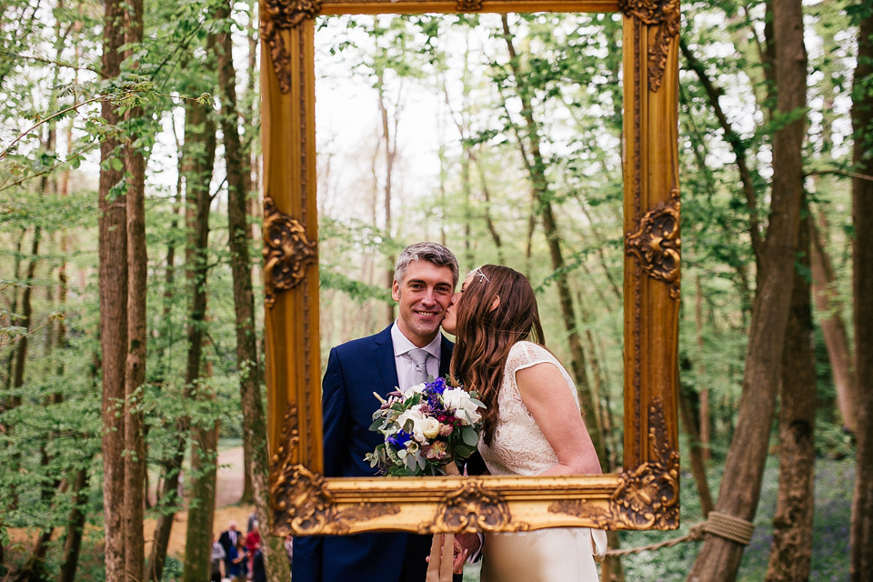 The bride wears a Sabina Motasem gown for her rustic, festival style wedding with glamping near the forrest. Photography by Joanna Nicole.