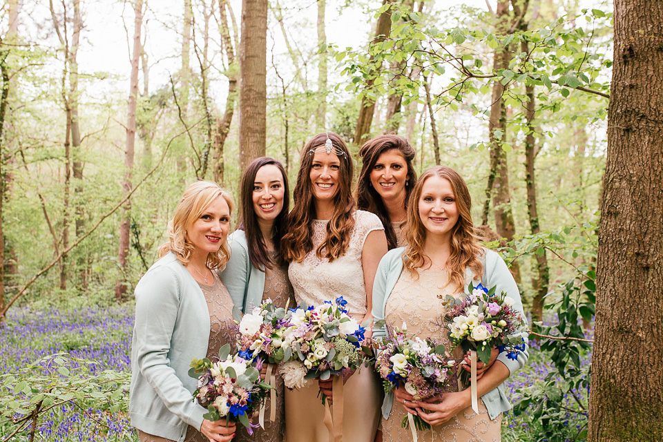 The bride wears a Sabina Motasem gown for her rustic, festival style wedding with glamping near the forrest. Photography by Joanna Nicole.
