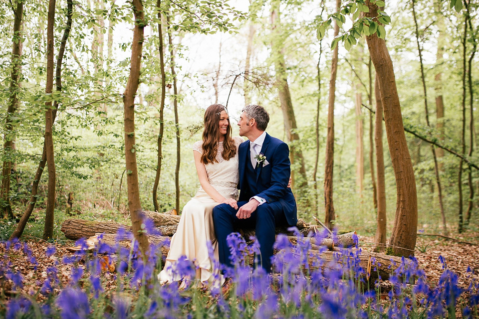 The bride wears a Sabina Motasem gown for her rustic, festival style wedding with glamping near the forrest. Photography by Joanna Nicole.