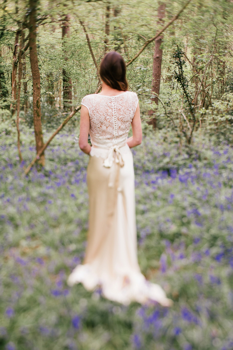 The bride wears a Sabina Motasem gown for her rustic, festival style wedding with glamping near the forrest. Photography by Joanna Nicole.