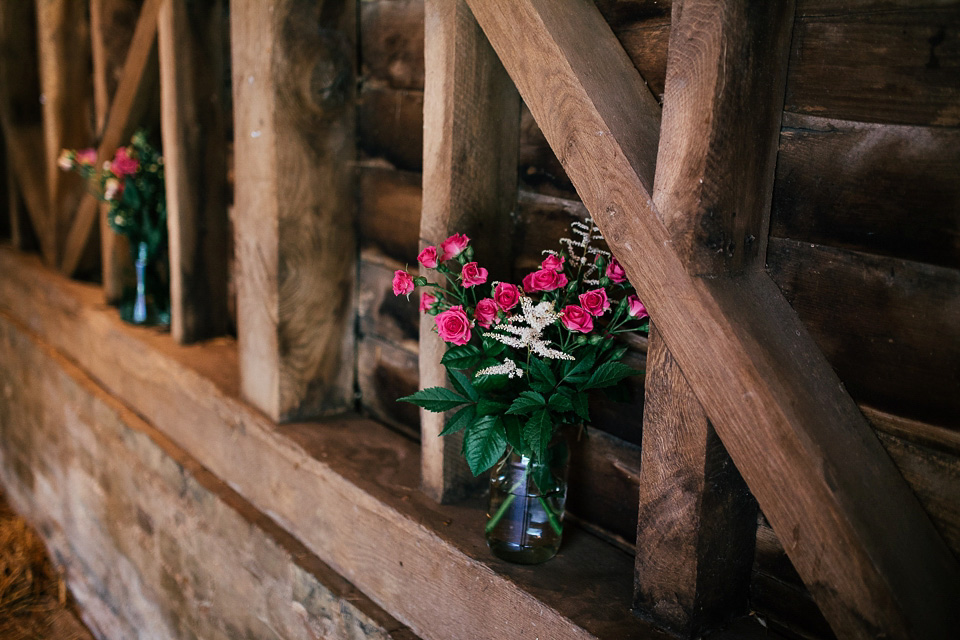 The bride wears a Sabina Motasem gown for her rustic, festival style wedding with glamping near the forrest. Photography by Joanna Nicole.