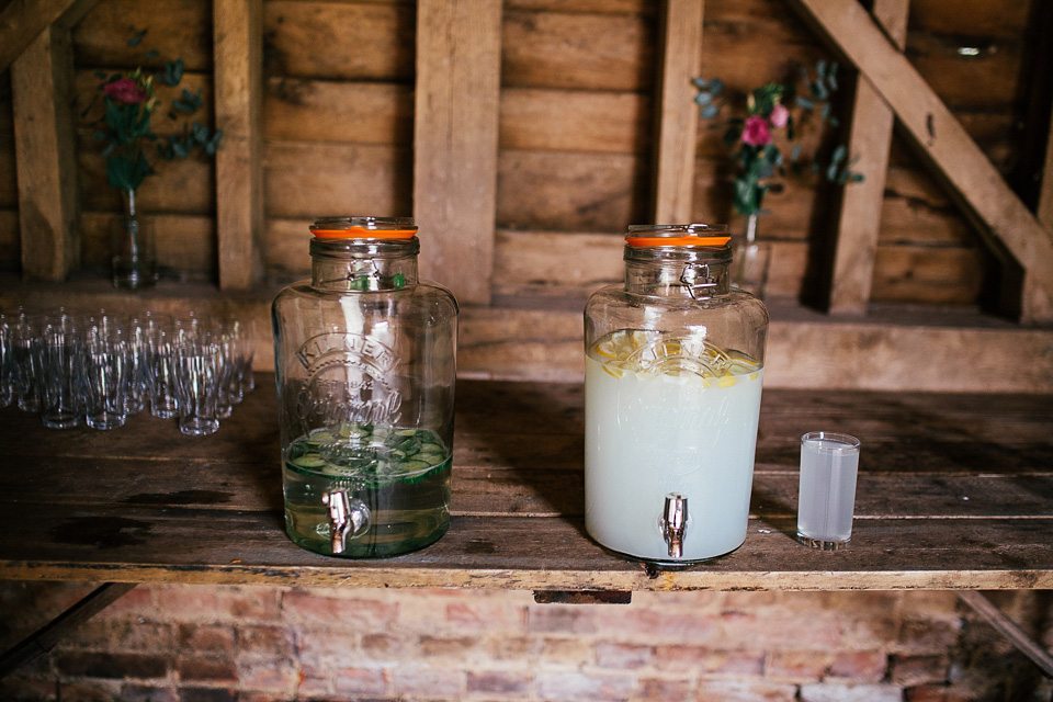 The bride wears a Sabina Motasem gown for her rustic, festival style wedding with glamping near the forrest. Photography by Joanna Nicole.