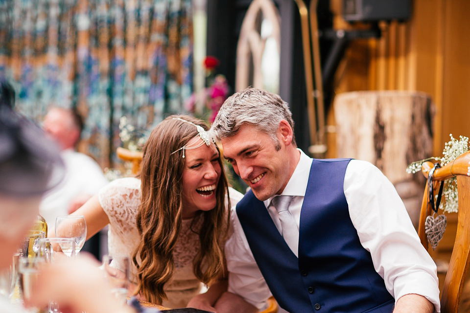 The bride wears a Sabina Motasem gown for her rustic, festival style wedding with glamping near the forrest. Photography by Joanna Nicole.